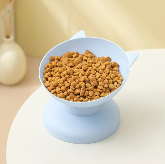 Blue elevated pet food bowl with cat ear design, filled with dry kibble, non-slip raised feeding dish for cats and small dogs
