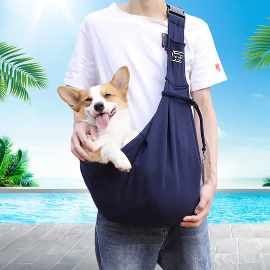 Happy corgi in a navy blue pet sling carrier bag – hands-free dog travel pouch for small and medium pets